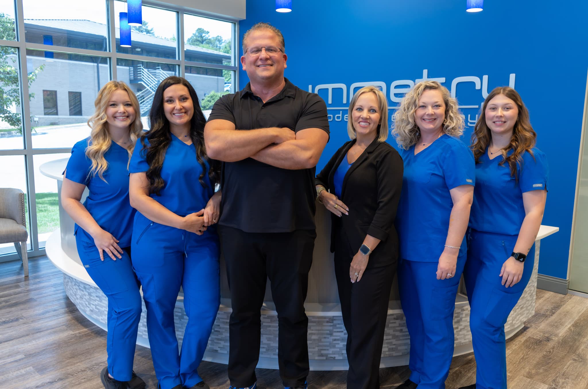Dr. Deal and the Symmetry Modern Dentistry team at the front desk